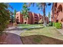 Exterior view of community with manicured lawn and pathway at 4303 E Cactus Rd # 441, Phoenix, AZ 85032