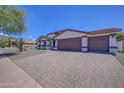 Front view of house with paver driveway and desert landscaping at 35925 N 30Th Dr, Phoenix, AZ 85086