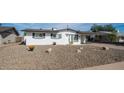 White single story home with a gravel front yard at 1642 W Capri Ave, Mesa, AZ 85202
