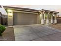 House exterior featuring a two-car garage and front yard landscaping at 20442 E Rosa Rd, Queen Creek, AZ 85142