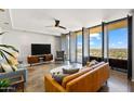 Spacious living room with city views and modern furniture at 207 W Clarendon Ave # 20B, Phoenix, AZ 85013
