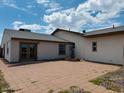 Rear view of house with patio and double doors at 51631 W Turney Ln, Maricopa, AZ 85139