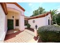 Home entrance with brick walkway, lush landscaping, and a charming door at 18997 N 74Th Dr, Glendale, AZ 85308