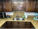 Kitchen with granite countertops, wood cabinets, and a double sink at 5132 N 31St Way # 114, Phoenix, AZ 85016
