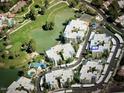 Aerial view showcasing the community's location near a lake and golf course at 5132 N 31St Way # 114, Phoenix, AZ 85016