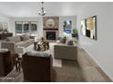 Bright living room with fireplace, tile floors, and access to backyard at 4801 E Nisbet Rd, Scottsdale, AZ 85254
