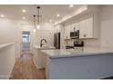 Modern kitchen with white cabinets and quartz countertops at 1917 E Hampton Ln # 109, Gilbert, AZ 85295