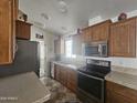 Modern kitchen with stainless steel appliances and wood cabinets at 8700 E University Dr # 339, Mesa, AZ 85207