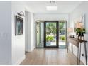 Bright and airy entryway with wood-look floors and large windows at 8901 N 87Th Ct, Scottsdale, AZ 85258