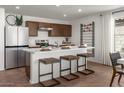 Modern kitchen with center island and stainless steel appliances at 5910 S 246Th Ln, Buckeye, AZ 85326