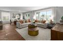 Spacious living room with large windows, and neutral color palette at 5910 S 246Th Ln, Buckeye, AZ 85326