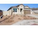 Single story home with two car garage and desert landscaping at 5420 S 253Rd Ln, Buckeye, AZ 85326