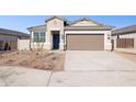 Single story home with two car garage and desert landscaping at 5420 S 253Rd Ln, Buckeye, AZ 85326