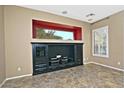Living room with large window and built-in entertainment center at 13055 W Eagle Talon Trl, Peoria, AZ 85383