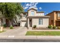 Two story house with attached garage and landscaped front yard at 1430 E Romley Ave, Phoenix, AZ 85040