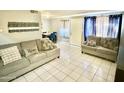 Living room with tiled floor, sofa, and dining area at 5418 W Belleview St, Phoenix, AZ 85043
