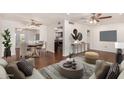 Open living and dining area with hardwood floors and a view into the kitchen at 10415 W Pleasant Valley Rd, Sun City, AZ 85351