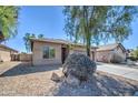 Tan colored house with a two-car garage and desert landscaping at 913 S 115Th Dr, Avondale, AZ 85323