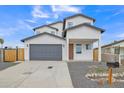 Modern two-story home with gray garage door and wood fence at 13036 N 20Th St, Phoenix, AZ 85022