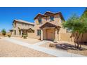 Two-story stucco home with a terracotta tile roof, shutters, and a welcoming front porch at 824 E Agua Fria Ln, Avondale, AZ 85323