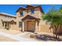Two-story stucco home with a terracotta tile roof, shutters, and a welcoming front porch at 824 E Agua Fria Ln, Avondale, AZ 85323
