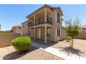 Two-story home with front porch and balcony at 847 E Agua Fria Ln, Avondale, AZ 85323