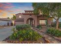 Two-story home with a large driveway and desert landscaping at 17797 W Carmen Dr, Surprise, AZ 85388