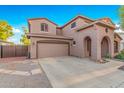 Two-story house with a large garage and desert landscaping at 17797 W Carmen Dr, Surprise, AZ 85388