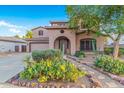 Two-story home with a large driveway and desert landscaping at 17797 W Carmen Dr, Surprise, AZ 85388