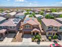 Aerial view of a house and neighborhood with solar panels at 21243 W Coronado Rd, Buckeye, AZ 85396