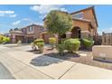 Two-story house with brown exterior, attached garage, and landscaping at 21243 W Coronado Rd, Buckeye, AZ 85396