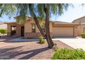 House exterior with stone accents, landscaping, and driveway at 19767 E Thornton Rd, Queen Creek, AZ 85142