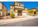 Two-story house with tan exterior, two-car garage, and landscaping at 11210 W Mckinley St, Avondale, AZ 85323
