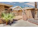 Private courtyard entry with wrought iron gates and brick walls at 19434 N 130Th Ave, Sun City West, AZ 85375