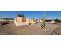 A light-colored house with boarded-up windows and a large cactus at 5416 E Akron St, Mesa, AZ 85205
