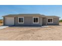 Newly built home with gray siding and attached garage at 14659 N Riverview Ct, Florence, AZ 85132