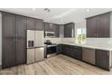 Modern kitchen with dark cabinetry and stainless steel appliances at 14659 N Riverview Ct, Florence, AZ 85132