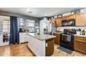 Kitchen features an island, stainless steel appliances, and ample cabinet space at 18535 W Udall Dr, Surprise, AZ 85374