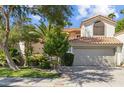 House exterior with two car garage and mature trees at 514 S Marina Dr, Gilbert, AZ 85233