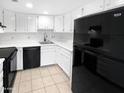 Small kitchen with white cabinets and black appliances at 2040 S Longmore -- # 80, Mesa, AZ 85202