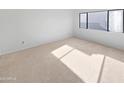 Simple bedroom with neutral carpet and large window at 2040 S Longmore -- # 80, Mesa, AZ 85202
