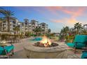 Community pool area with fire pit and lounge chairs at 2511 W Queen Creek Rd # 425, Chandler, AZ 85248