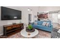 Living room with blue sofa and large flat-screen TV at 2511 W Queen Creek Rd # 425, Chandler, AZ 85248