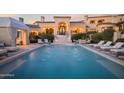 Resort-style pool with multiple lounge chairs and a cabana at 10947 E Wingspan Way, Scottsdale, AZ 85255