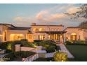 Elegant mansion with landscaped grounds at dusk at 10947 E Wingspan Way, Scottsdale, AZ 85255