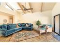 Living room with teal sectional sofa, fireplace, and high ceilings at 8638 E Paraiso Dr, Scottsdale, AZ 85255