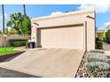 Tan home with a two-car garage and landscaped yard at 8638 E Paraiso Dr, Scottsdale, AZ 85255