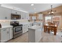 Modern kitchen with white cabinets, island, and stainless steel appliances at 11596 W Sierra Dawn Blvd # 377, Surprise, AZ 85378