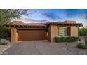 Attached two-car garage with desert landscaping at 39115 N 99Th Pl, Scottsdale, AZ 85262