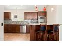 Modern kitchen with wood cabinets, granite countertops, and stainless steel appliances at 18112 W Spencer Dr, Surprise, AZ 85374